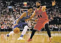  ?? FRANK GUNN/THE CANADIAN PRESS VIA AP ?? Toronto Raptors guard DeMar DeRozan, left, drives past Chicago Bulls forward Nikola Mirotic during the second half of Tuesday’s game in Toronto.