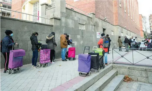  ?? EP ?? Un grupo de personas espera para recibir comida de la Fundación Madrina, en Madrid