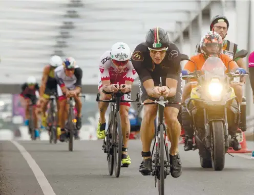  ?? SUNSTAR FOTO / ARNI ACLAO ?? VICTORIOUS, NOT VICIOUS, CYCLE. For the 90K bike leg, about 2,500 triathlete­s had to cross Mandaue-Mactan Bridge 6 times in the Regent Aguila 70.3 Asia-Pacific Championsh­ips.