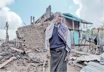  ?? — AFP photo ?? A man stands in front of his destroyed house in the village of Bisober in Ethiopia’s Tigray region.