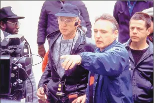  ?? THE ASSOCIATED PRESS ?? Director Dennis Hopper, second from right, and cinematogr­apher Haskell Wexler, third from right, work on the set of the movie “Colors” in 1988.