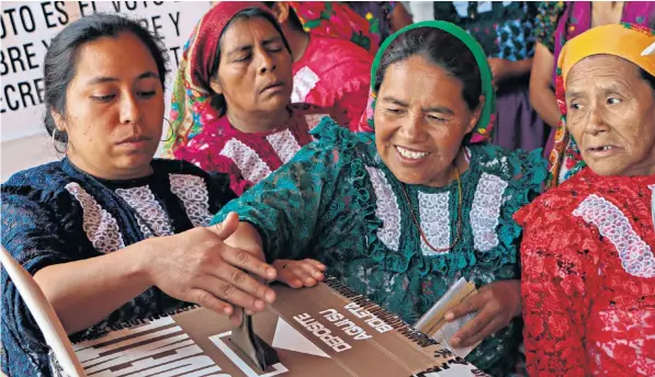  ??  ?? Women vote in San Bartolome Quianala, Oaxaca State, yesterday in the most important presidenti­al election to take place in Mexico in a generation