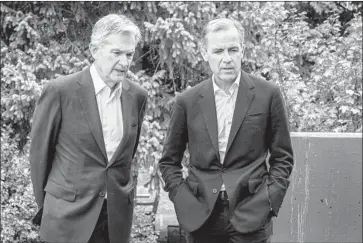  ?? Amber Baesler Associated Press ?? FEDERAL RESERVE Chairman Jerome Powell, left, and Bank of England Gov. Mark Carney chat after Powell’s speech Friday at the Kansas City Fed’s annual economic policy symposium in Jackson Hole, Wyo.