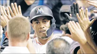  ??  ?? MIAMI FEAT? Giancarlo Stanton celebrates his three-run homer — his 55th of the season — in the fourth inning against the Mets on Monday. It moves him closer to breaking Roger Maris’ mark of 61 homers, a number many see as the real single-season record....