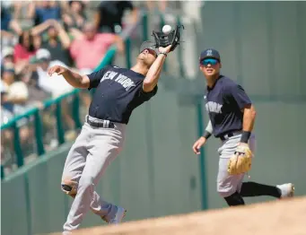  ?? AP ?? Yankees shortstop Isiah Kiner-falefa catches the ball during a game against the Red Sox on Sunday. With added competitio­n for the shortstop position, the Yankees are having the veteran work out on center field.
