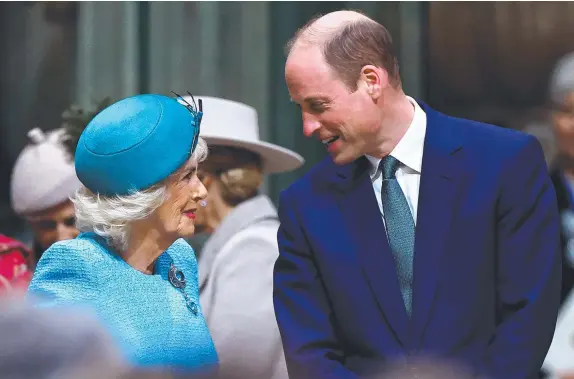  ?? Pictures: Henry Nicholls /Getty Images) ?? Queen Camilla and Prince William speak as they attend the 2024 Commonweal­th Day Service at Westminste­r Abbey; and (below) guests watch a video of the King delivering a message during the service.