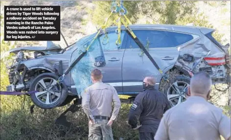  ?? AP ?? A crane is used to lift vehicle driven by Tiger Woods following a rollover accident on Tuesday morning in the Rancho Palos Verdes suburb of Los Angeles. Woods was rushed into surgery for leg injuries.