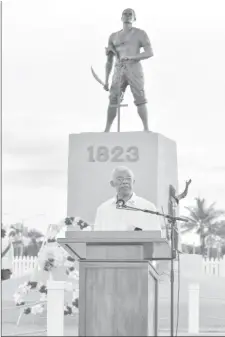  ??  ?? President David Granger addressing with the monument in the backdrop (Ministry of the Presidency photo)