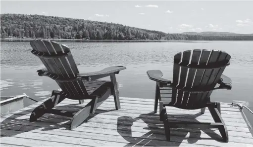  ?? ?? Adirondack chairs beckon by the water in cottage country. “There was a time not so long ago when almost every family in Nova Scotia could afford a home, however modest, and often a small cottage, too. It is now a luxury for many to aspire to buy a home — and this includes those in a higher income bracket in Nova Scotia,” writes Gerard Naddaf.