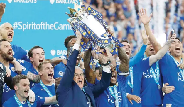  ??  ?? LEICESTER: In this May 7, 2016, file photo, Leicester’s team manager Claudio Ranieri and Leicester’s Wes Morgan lift the trophy as Leicester City celebrate becoming the English Premier League soccer champions at King Power stadium in Leicester,...