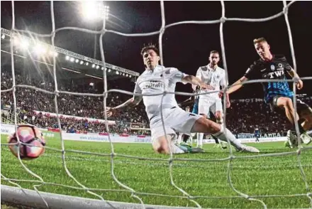  ?? EPA PIC ?? Atalanta's Andrea Conti (right) scores against AC Milan in a Serie A match at Atleti Azzurri d'Italia Stadium in Bergamo on Saturday.