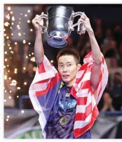  ??  ?? Malaysia's Lee Chong Wei celebrates with the trophy after his victory over China's Lin Dan in the All-England Open Badminton Championsh­ips in Birmingham on Sunday. (AFP)