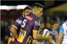  ?? PHOTO: KEVIN FARMER ?? TRIAL GAME: Brisbane Broncos winger Jordan Kahu takes on the Gold Coast Titans line during their trial game at Clive Berghofer Stadium on Saturday night.