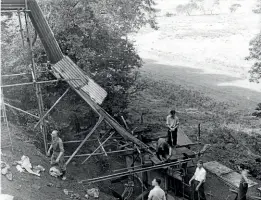  ?? TR ARCHIVES ?? A chute made of scaffoldin­g, corrugated tin sheet and wood for tipping concrete to create a retaining wall at the bottom of the Dolgoch landslip.