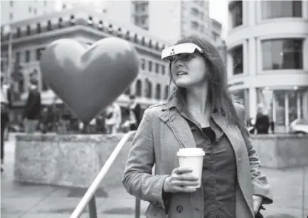  ??  ?? Yvonne Felix, wearing eSight electronic glasses, looks around Union Square in San Francisco during a visit Feb. 2. Felix was diagnosed with Stargardt’s disease after being hit by a car at the age of 7. Eric Risberg, The Associated Press