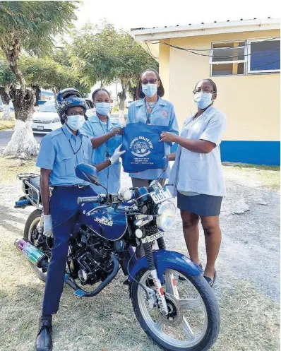  ??  ?? The Drug Serv team from the Princess Margaret Hospital in St Thomas is all set and ready to provide home delivery services to elderly clients in and around St Thomas. From left: Kimone Palmer, pharmacy technician; Opal Haughton, pharmacy technician; and pharmacist Vickeshia Young hand over medication to Lebert Saunders for home delivery. The team visited the communitie­s of Lyssons, Retreat, Prospect and Leith Hall on April 27.