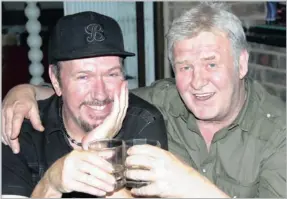  ??  ?? Don Clarke, left, with Leon Schuster, toasting to Schuster’s new candid camera film.