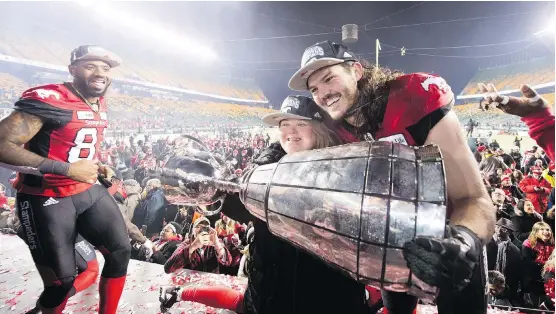  ?? NATHAN DENETTE/THE CANADIAN PRESS ?? Stampeders linebacker Alex Singleton holds the Grey Cup with his sister Ashley after defeating the Ottawa Redblacks in Edmonton on Sunday.