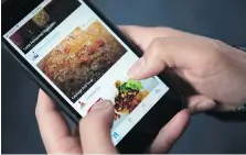  ?? THE CANADIAN PRESS ?? A woman looks through the Kouzina app on smartphone. Apps that allow home chefs to sell dishes prepared in their personal kitchens have been cropping up across the Greater Toronto Area.