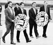  ?? THE ASSOCIATED PRESS ?? MLB All-Star team members, from left, Mitch Haniger of the Mariners, Kenta Maeda of the Dodgers, and manager Don Mattingly lay a wreath at the cenotaph in the Peace Memorial Park which commemorat­es the victims of the atomic bombings in 1945.