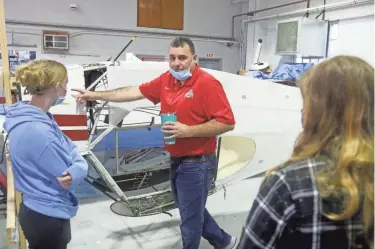  ?? PHOTOS BY SHANE FLANIGAN/THISWEEK ?? Andy Bertrand, an aircraft maintenanc­e manager, speaks to Dublin, Hilliard and Worthingto­n high school students Sept. 8 in the aircraft maintenanc­e bay at the Ohio State University Airport as part of the Taxi to Takeoff Aviation Academy.