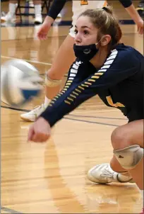  ??  ?? Clarkston senior Claire Nowicki digs a ball during the second set of the Wolves’ three-set win over Troy in the Division 1 regional semifinal at Stoney Creek High School. The Wolves, who improved to 27-8, face Eisenhower in today’s regional final.
