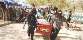  ?? ?? Pall bearers carry the casket bearing the body of the late Cont Mhlanga in Lupane yesterday