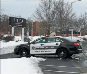  ?? CHARLES PRITCHARD — ONEIDA DAILY DISPATCH ?? A police car waits outside Utica College on Monday, March 5, 2018, after the school received a “real, credible threat” and went into lock down.