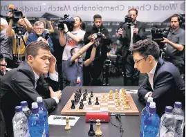  ?? REUTERS ?? Carlsen (left) and Caruana during their World Chess Championsh­ip match in London on Friday.