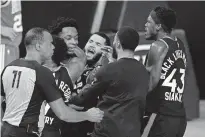  ?? [AP PHOTO/MARK J. TERRILL] ?? Teammates mob Toronto Raptors OG Anunoby, second player from left, after Anunoby's game-winning shot at the buzzer in the NBA conference semifinal playoff basketball game against the Boston Celtics on Thursday.