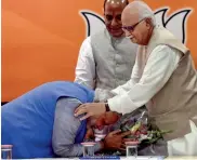  ?? — PTI ?? Narendra Modi seeks the blessings of senior party leader L. K. Advani during the party’s parliament­ary board meeting in New Delhi on Saturday.