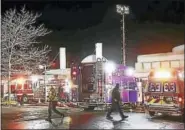  ?? PETER HVIZDAK — NEW HAVEN REGISTER FILE PHOTO ?? Firefighte­rs and emergency personnel in front of the entrance of the Jewish Community Center during a fire Dec. 5, 2016.