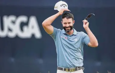  ?? Warren Little/Getty Images ?? Canada’s Adam Hadwin reacts on the ninth green during the first round Thursday at The Country Club in Brookline, Mass. Hadwin is alone atop the leaderboar­d after firing a 4-under 66.