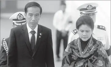  ?? Joseph Nair
Associated Press ?? PRESIDENT Joko Widodo, seen here with his wife, Iriana Joko Widodo, has gotten some praise along with the criticism, and an analyst noted that his election may have generated unrealisti­c expectatio­ns.