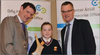  ??  ?? Sola Plue, Sacred Heart winner of the Junior Section in the LEO Louth Student Enterprise Competitio­n pictured receiving her award from Cllr. Colm Markey, Chairman of Louth County Council and Thomas McEvoy, Head of Enterprise, LEO Louth.