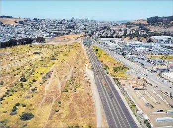  ?? Photograph­s by Josh Edelson For The Times ?? AMID A STIFLING housing shortage, a developer has proposed a 4,400-unit project for this 640-acre lot in the Bay Area city of Brisbane. But the town, population 4,700, has final say — and its residents are wary.