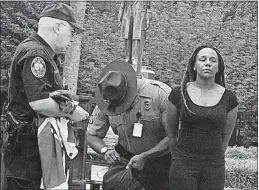  ?? [BRUCE SMITH/THE ASSOCIATED PRESS] ?? On June 27, 2015, Bree Newsome of Charlotte, N.C., was taken into custody after she removed the Confederat­e flag from a monument in front of the South Carolina Statehouse in Columbia, S.C. She was reacting to the attack at a Charleston church where a...