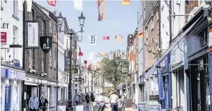  ??  ?? ●● Barnaby washing lines have been strung up around the town centre, below, John Bramwell, from I am Kloot, is headlining the music event