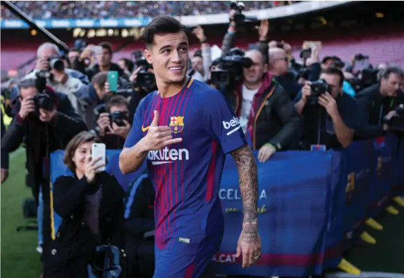  ?? EPA ?? Brazilian midfielder Philippe Coutinho poses on the pitch during his presentati­on by Barcelona. A thigh injury will keep him out of immediate action