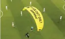  ?? Photograph: Alexander Hassenstei­n/AP ?? The German players look on as a Greenpeace paraglider lands in the stadium before the Euro 2020 match between France and Germany.