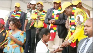  ??  ?? President Mnangagwa hands over a prize to 5km marathon overall winner Betha Chikanga at the ZANU-PF Youth League Convention at Mkoba open space in Gweru yesterday. —Pictures by Tawanda Mudimu