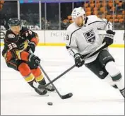  ?? Mark J. Terrill Associated Press ?? THE DUCKS’ Jakob Silfverber­g, left, tries to get the puck away from the Kings’ Michael Amadio.