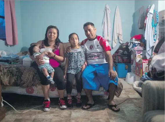  ?? PHOTOS: ZACK WITTMAN/THE WASHINGTON POST ?? Catalina Sanchez and Cirilo Perez with children Gustavo and Miriam in the main room of their trailer in Wimauma, Fla., where Perez works in the tomato fields, “I don’t like what I’m doing but I do it to make a living, and I find joy in that,” Perez...