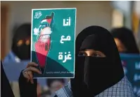  ?? A WOMAN holds up a sign with in support of Palestinia­ns in Gaza, in Mosul, Iraq, in October. ??