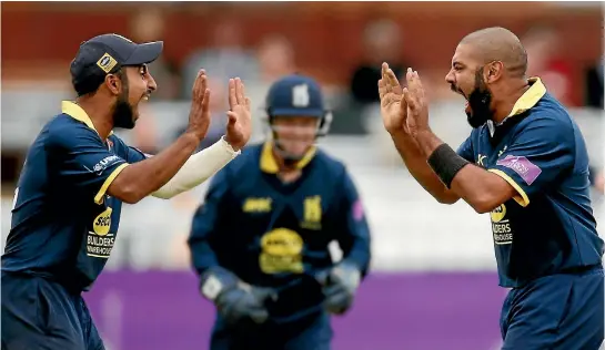  ?? PHOTO: REUTERS ?? Yet another English wicket falls for Jeetan Patel, right, as he celebrates with Warwickshi­re team-mate Ateeq Javid on the way to the team’s one-day final victory over Surrey at Lord’s.