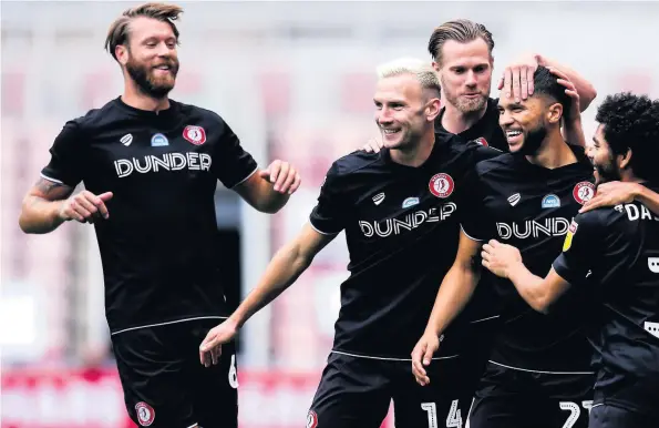  ??  ?? Bristol City players congratula­te Nahki Wells, third right, after he opened the scoring in Saturday’s game at the Riverside