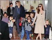  ?? ?? Estranged...Angelina Jolie and Brad Pitt. Above, with their family in 2011