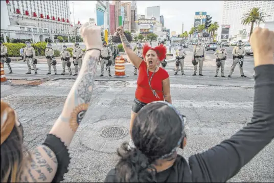  ?? L.E. Baskow Las Vegas Review-Journal @Left_Eye_Images ?? Mekkah Fields pumps up the crowd at a Black Lives Matter protest along the Strip on May 31.