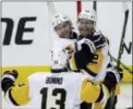  ?? ALEX BRANDON — THE ASSOCIATED PRESS ?? Pittsburgh’s Conor Sheary and Patric Hornqvist, right, celebrate with Nick Bonino (13) after Hornqvist’s goal during the third period of Game 7 Wednesday in Washington.