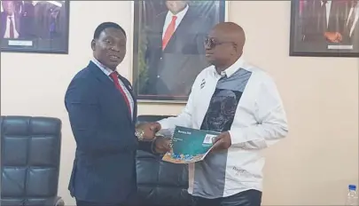 ??  ?? TO AFRICAN BROTHERHOO­D . . . Daniel Amokachi (left) presents the Morocco World Cup bid document to Philip Chiyangwa at the ZIFA president’s office in Harare
